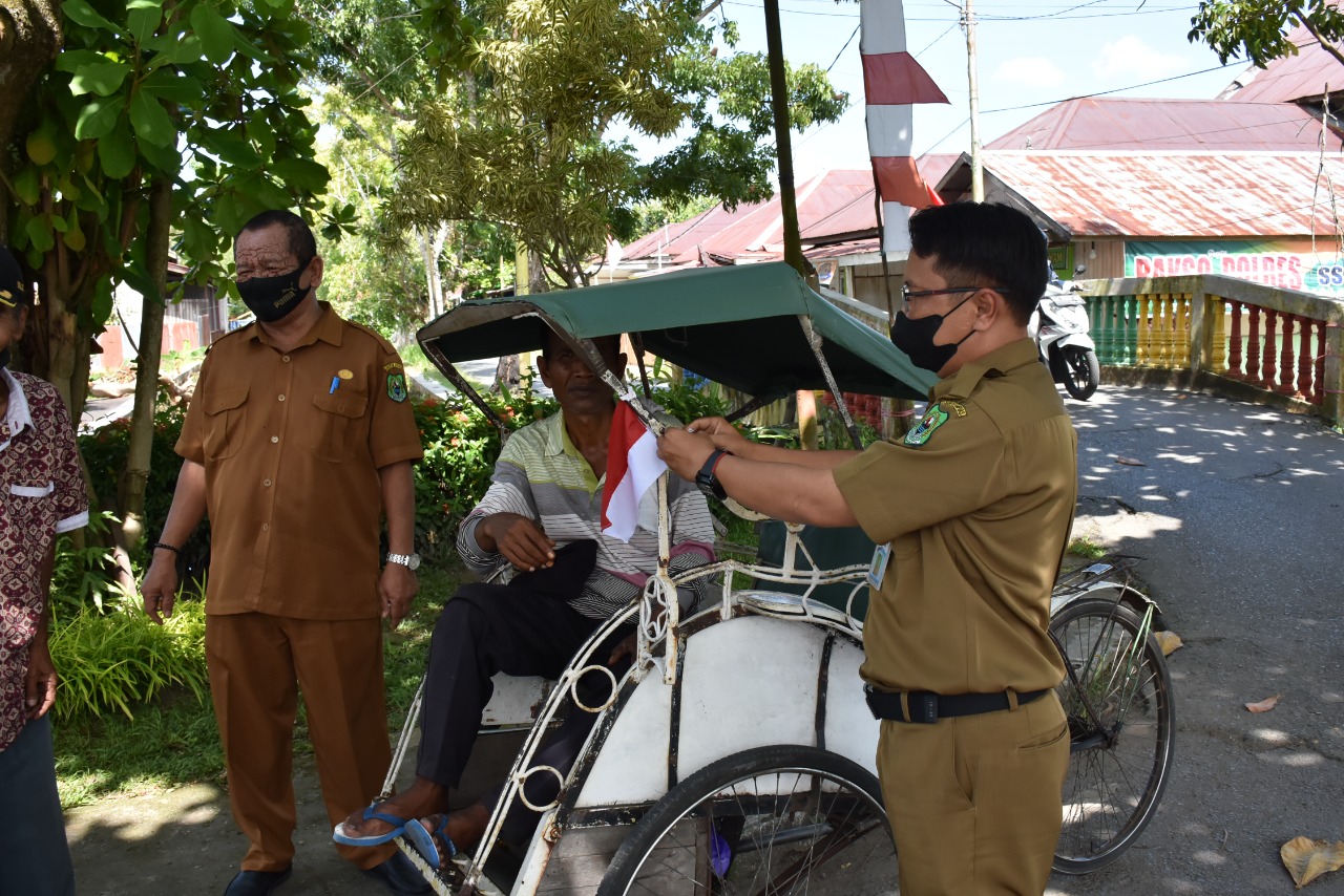 Diskominfo Kapuas Lakukan Pembagian Bendera Merah Putih Kepada Masyarakat